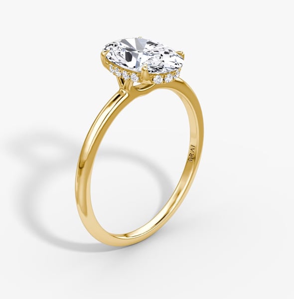 Signature hidden halo oval engagement ring